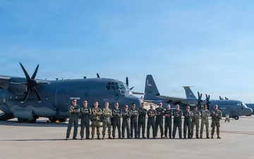 U.S. Air Force airmen pose with C-130 Hercules aircraft on flight line
