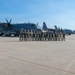 U.S. Air Force airmen pose with C-130 Hercules aircraft on flight line