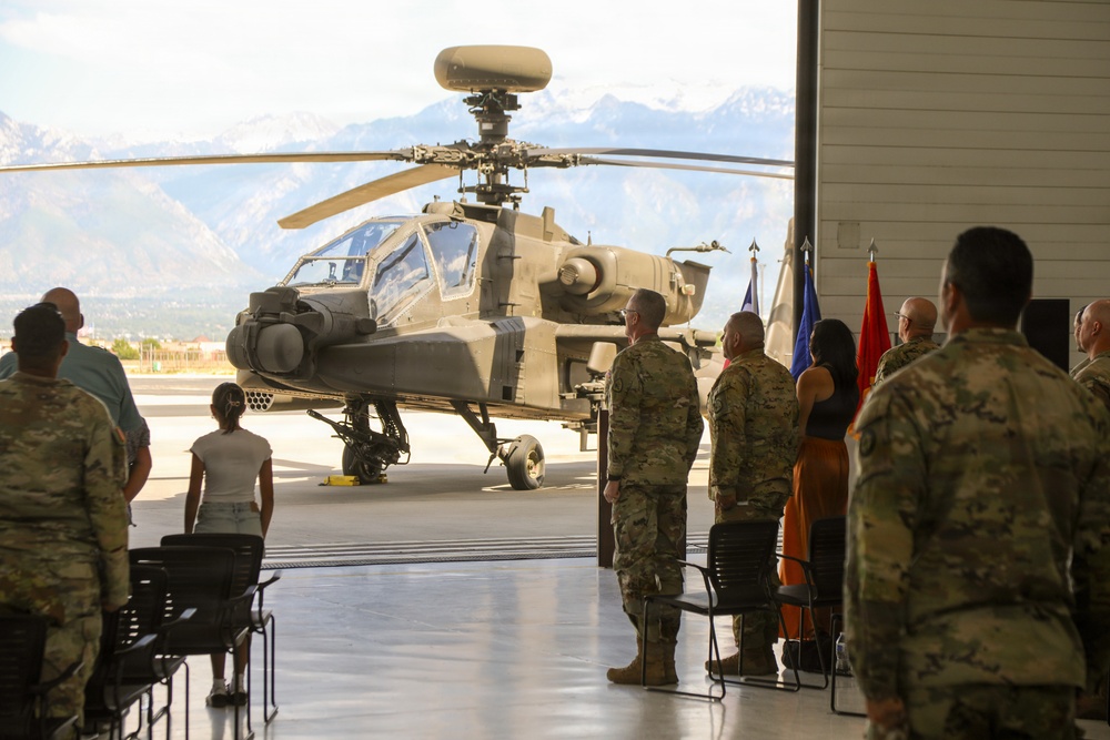 Army AH-64 Apache helicopter on display during military ceremony at mountain installation