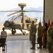 Army AH-64 Apache helicopter on display during military ceremony at mountain installation
