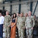 U.S. Army soldiers and civilians stand at attention during a ceremony inside a military aviation hangar