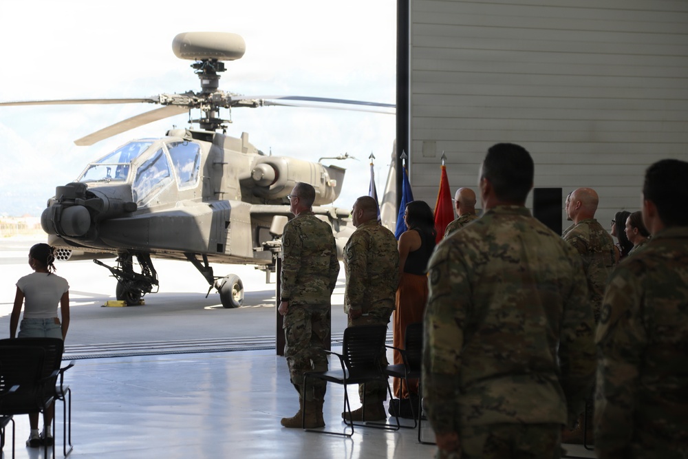 Col. Noe Vasquez is promoted to the rank of colonel held in aircraft hangar with AH-64 Apache attack helicopter on display