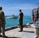 U.S. Sailor and Marine watch surface vessel depart during RIMPAC 26