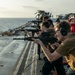 USS Tripoli Conducts A Sunrise Gun Shoot