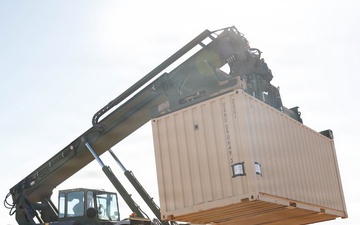 U.S. Army soldier operate a rough terrain container handler during logistics training exercise