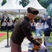Pak places a flower in tribute