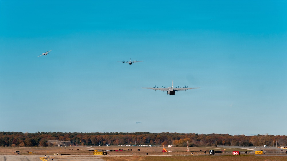 143d Airlift Wing conducts a 7-ship C-130J Hercules flyover