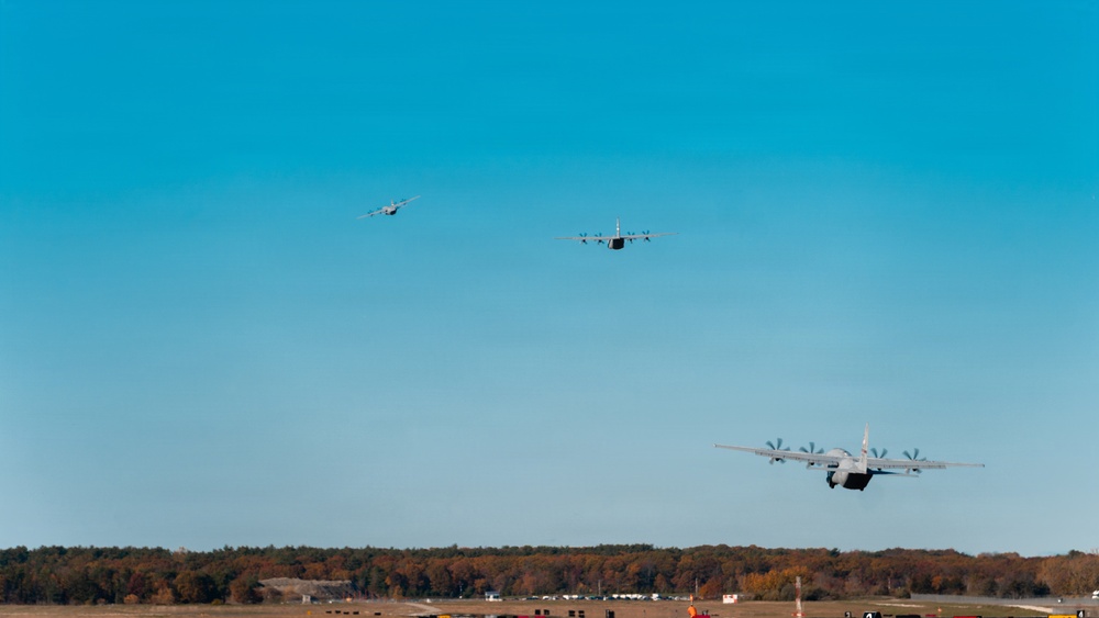 143d Airlift Wing conducts a 7-ship C-130J Hercules flyover