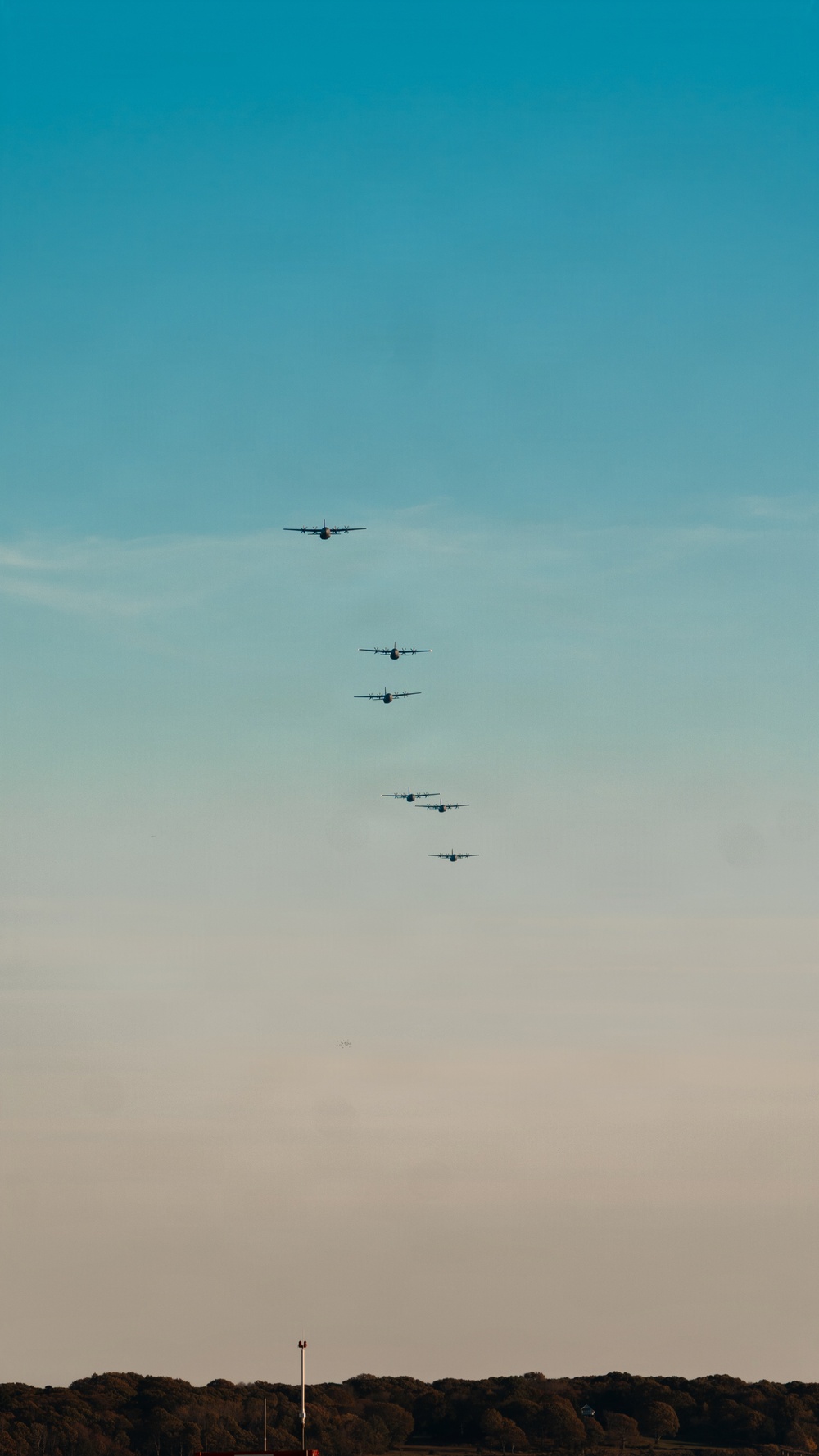 143d Airlift Wing conducts a 7-ship C-130J Hercules flyover