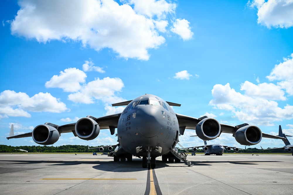 15th Airlift Squadron conducts Salute from the Shore flyover
