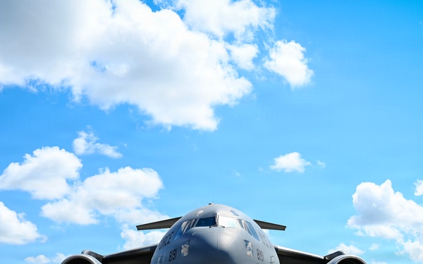 15th Airlift Squadron conducts Salute from the Shore flyover