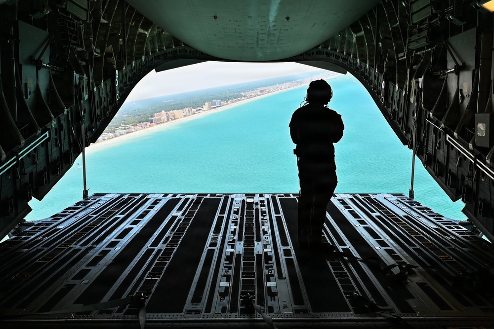 15th Airlift Squadron conducts Salute from the Shore flyover