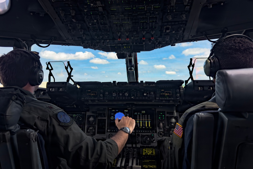 15th Airlift Squadron conducts Salute from the Shore flyover