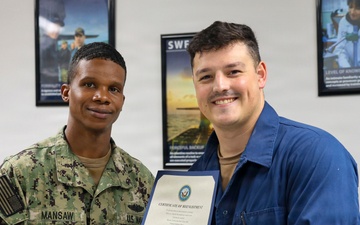 Missile Technician 1st Class Trenton Musa Re-enlists