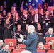 U.S. Army conductor leads military band and civilian choir during patriotic concert performance