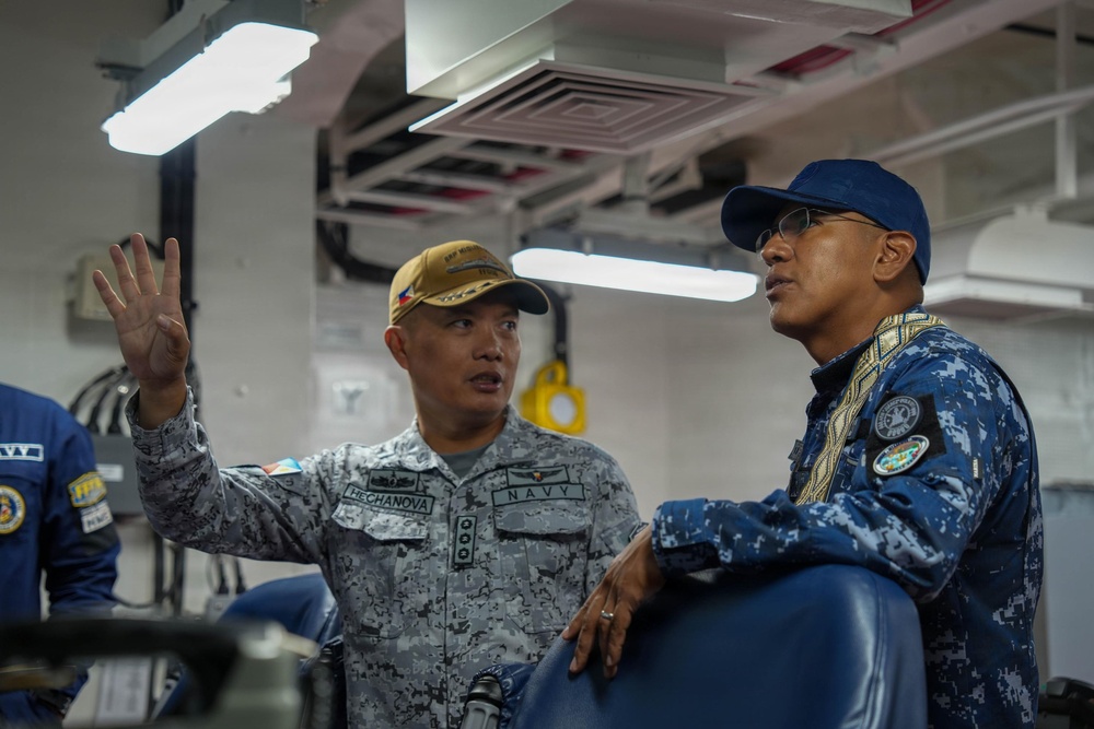 BRP Miguel Malvar commanding officer briefs skipper of ARM Benito Juarez aboard Philippine Navy ship during RIMPAC 26