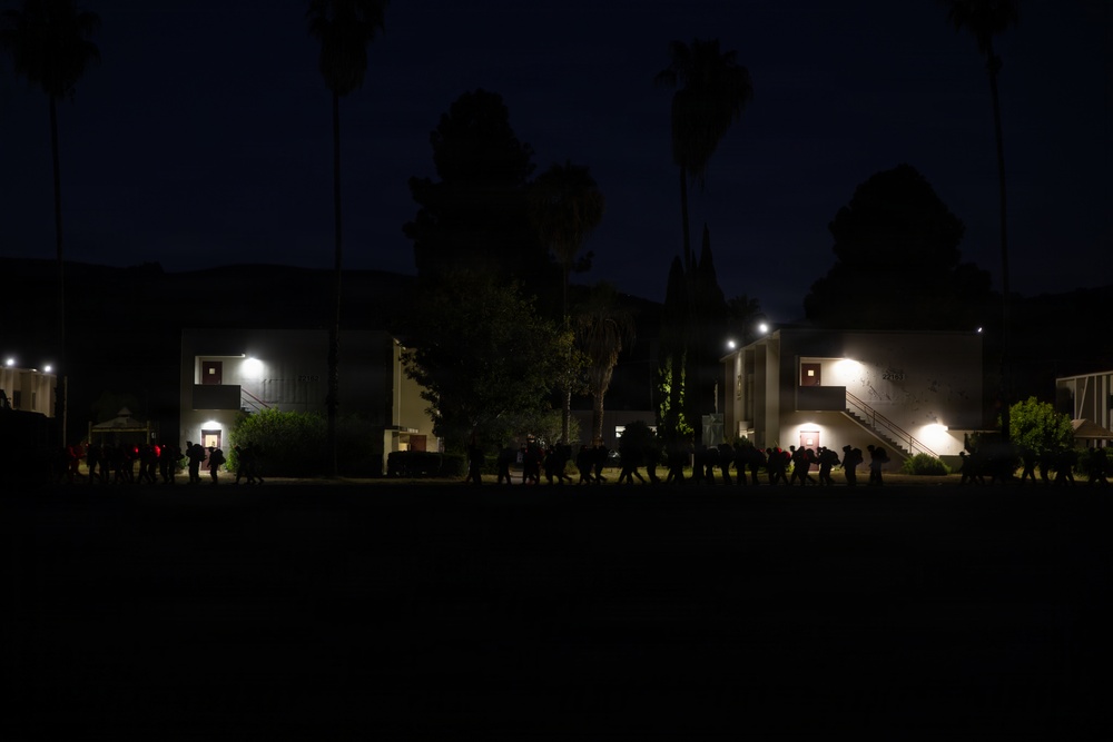 1st Combat Readiness Regiment Marines and Sailors participate in a 10k night hike