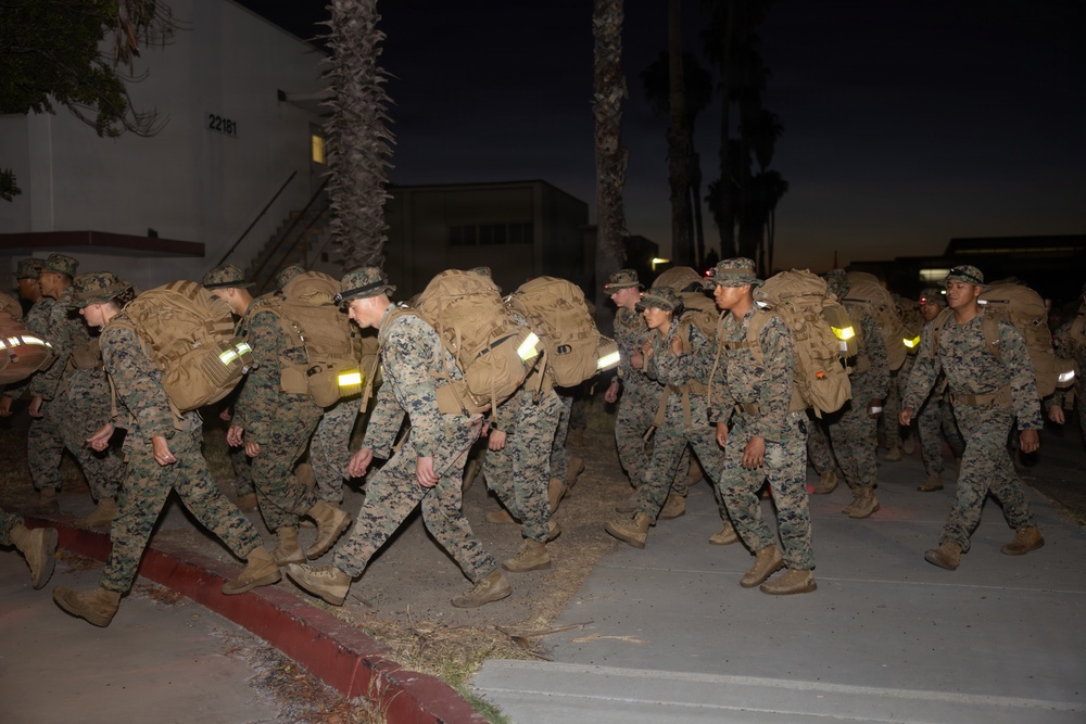 1st Combat Readiness Regiment Marines and Sailors participate in a 10k night hike