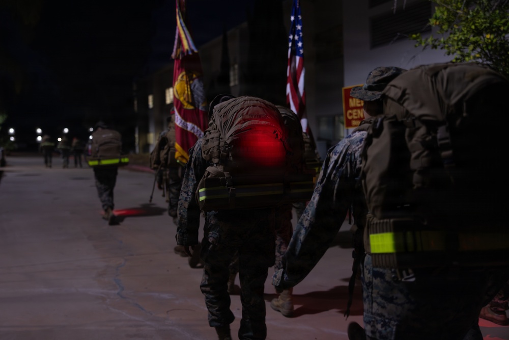 1st Combat Readiness Regiment Marines and Sailors participate in a 10k night hike
