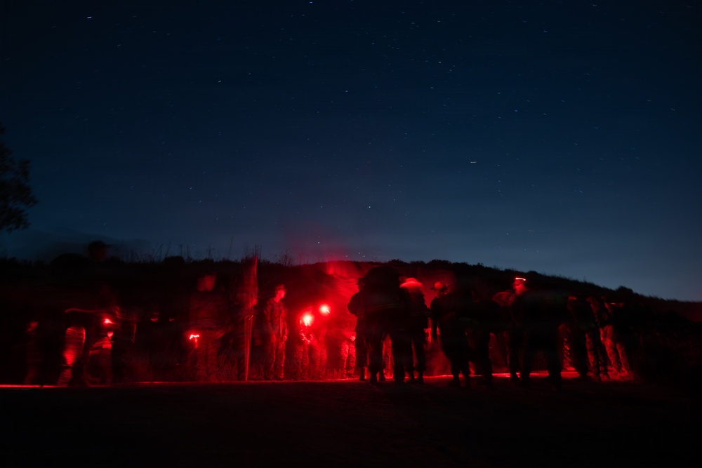 1st Combat Readiness Regiment Marines and Sailors participate in a 10k night hike