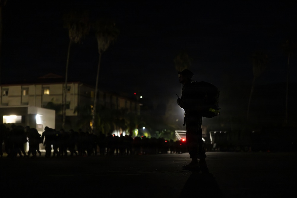 1st Combat Readiness Regiment Marines and Sailors participate in a 10k night hike