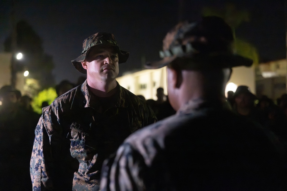 1st Combat Readiness Regiment Marines and Sailors participate in a 10k night hike