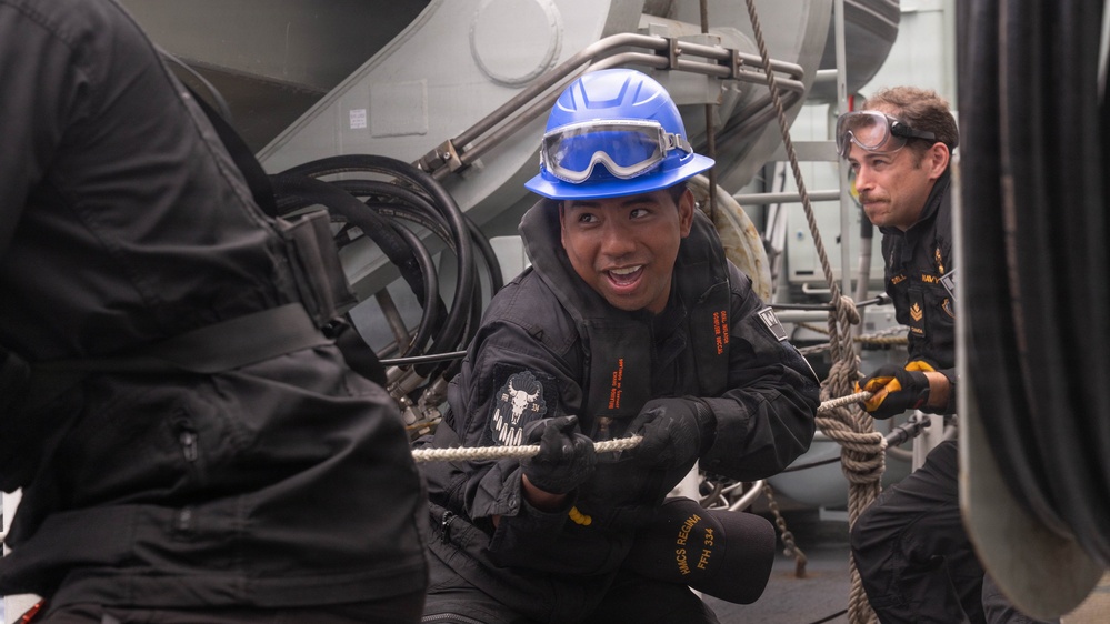 Canadian Sailor of RCN Halifax Class Frigate Regina (FFH 334) participate in replenishment at sea with HMNZS Aotearoa (A11)