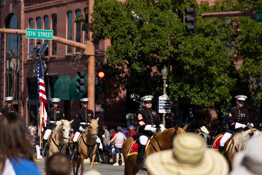 U.S. Marine Corps Mounted Color Guard participates in the Cody Stampede