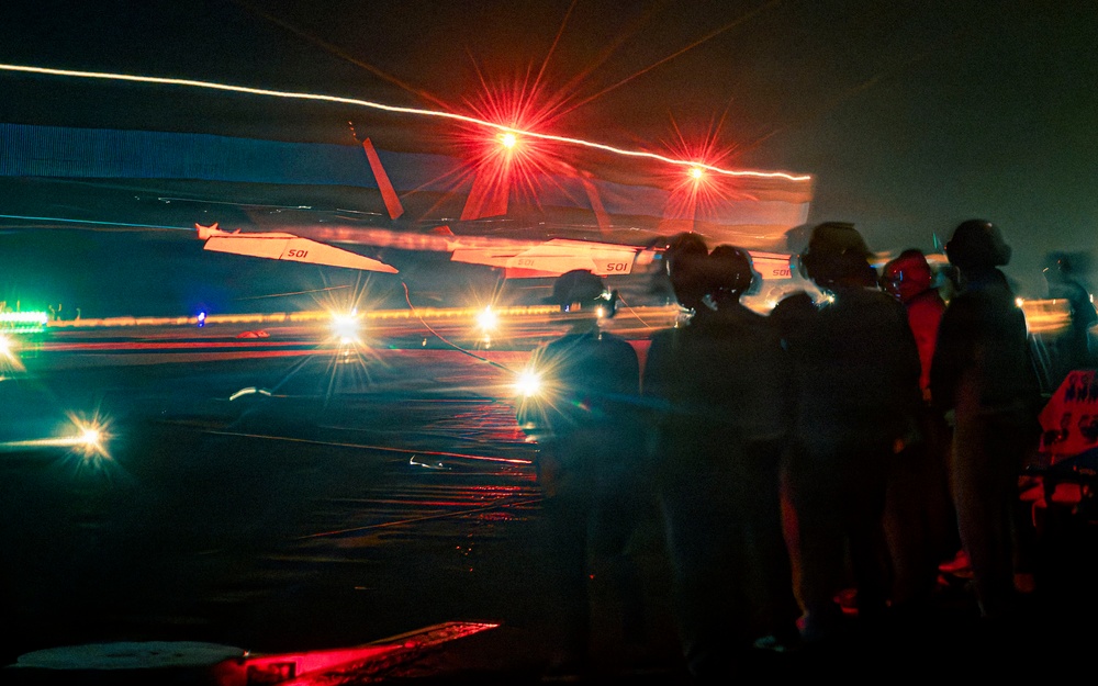 Distinguished visitors observe night flight operations onboard Nimitz-class aircraft carrier USS Theodore Roosevelt (CVN 71) during RIMPAC 26
