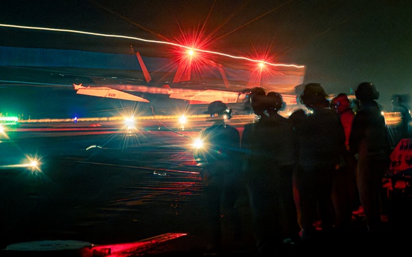Distinguished visitors observe night flight operations onboard Nimitz-class aircraft carrier USS Theodore Roosevelt (CVN 71) during RIMPAC 26