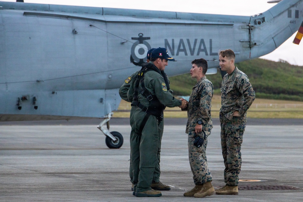 U.S. Marines, Peruvian Navy service members refuel SH-3 Sea King helicopter