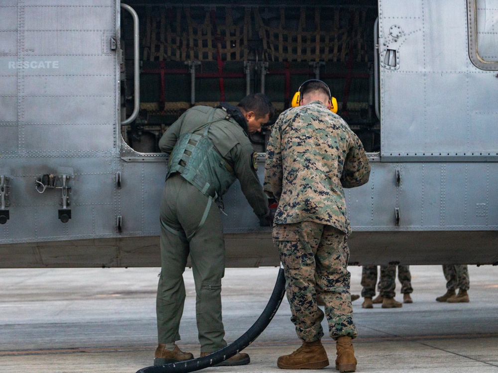 U.S. Marines, Peruvian Navy service members refuel SH-3 Sea King helicopter