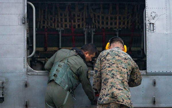 U.S. Marines, Peruvian Navy service members refuel SH-3 Sea King helicopter