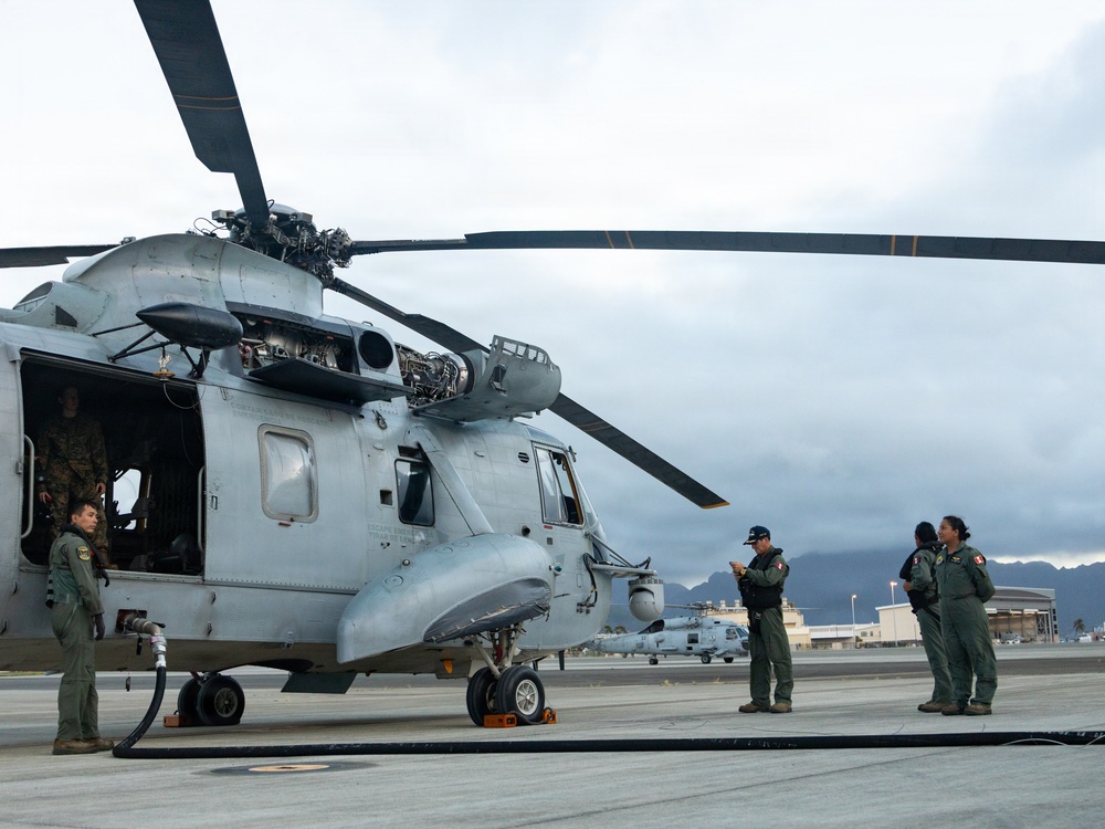 U.S. Marines, Peruvian Navy service members refuel SH-3 Sea King helicopter