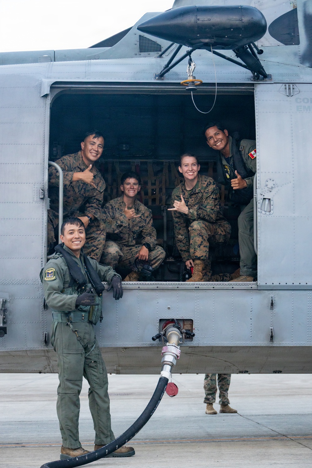 U.S. Marines, Peruvian Navy service members refuel SH-3 Sea King helicopter