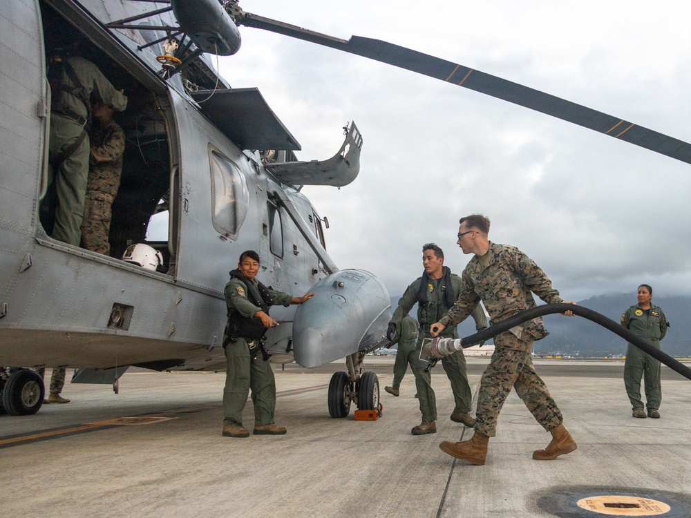 U.S. Marines, Peruvian Navy service members refuel SH-3 Sea King helicopter
