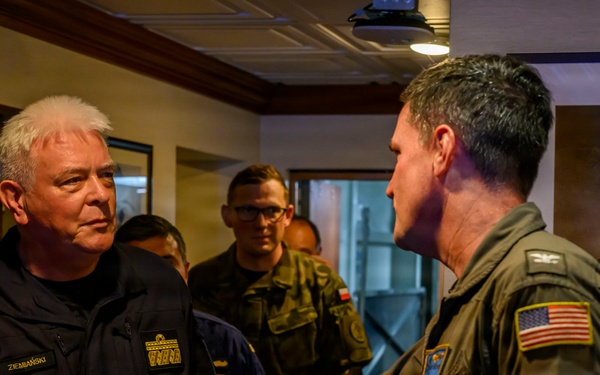 USS Theodore Roosevelt (CVN 71) Commanding Officer greets Polish Navy Rear Admiral during RIMPAC 26