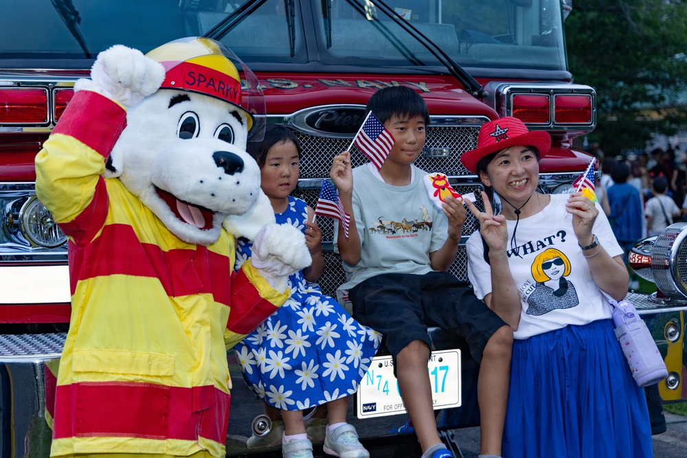 Sasebo community members pose for a photo with Sparky during Independence Day celebration