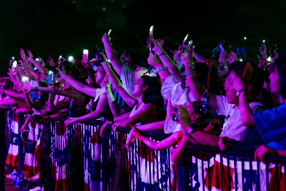 Sailors, family members, and Sasebo community members watch a concert during the Independence Day celebration