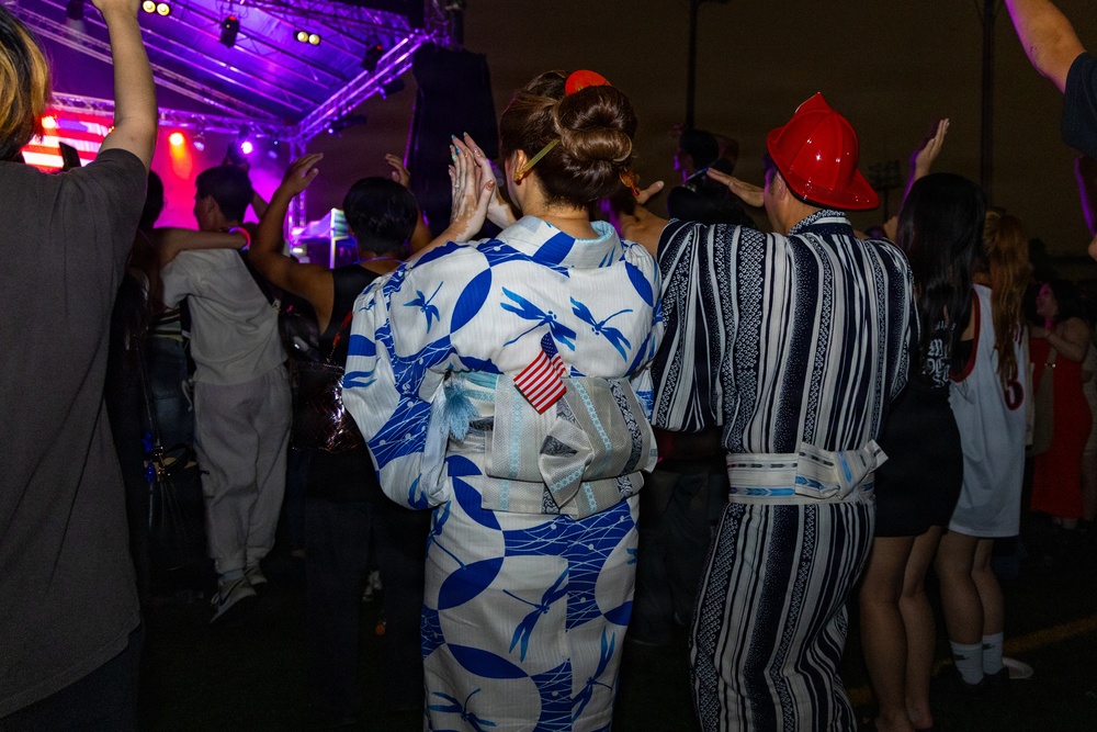 Sasebo community members watch a performance during Independence Day celebration