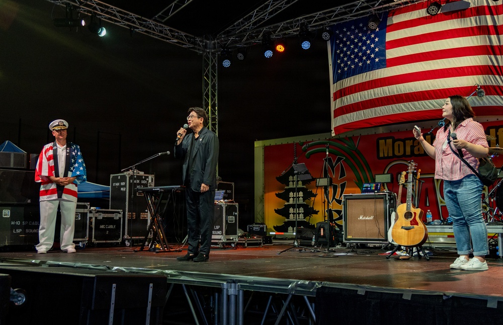 Sasebo City Mayor Daisuke Miyajima delivers closing remarks during the Independence Day celebration