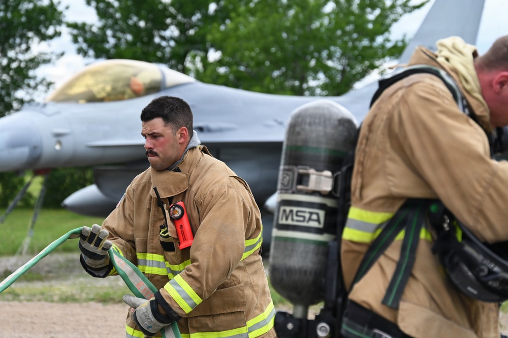 119th Wing Fire Crew Chief Advances Hose Line