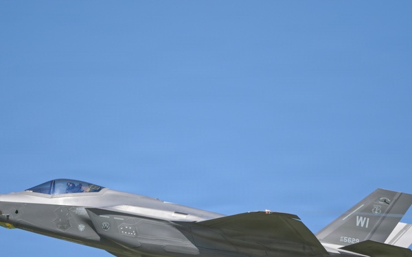 A U.S. Air Force F-35A Lightning II stealth fighter jet is captured in level flight against a clear blue sky. The aircraft bears the tail code 'WI' indicating assignment to a Wisconsin Air National Guard unit, with a visible serial number '5629'. The image is a high-quality side-profile photograph showing significant detail of the aircraft's stealth airframe design.