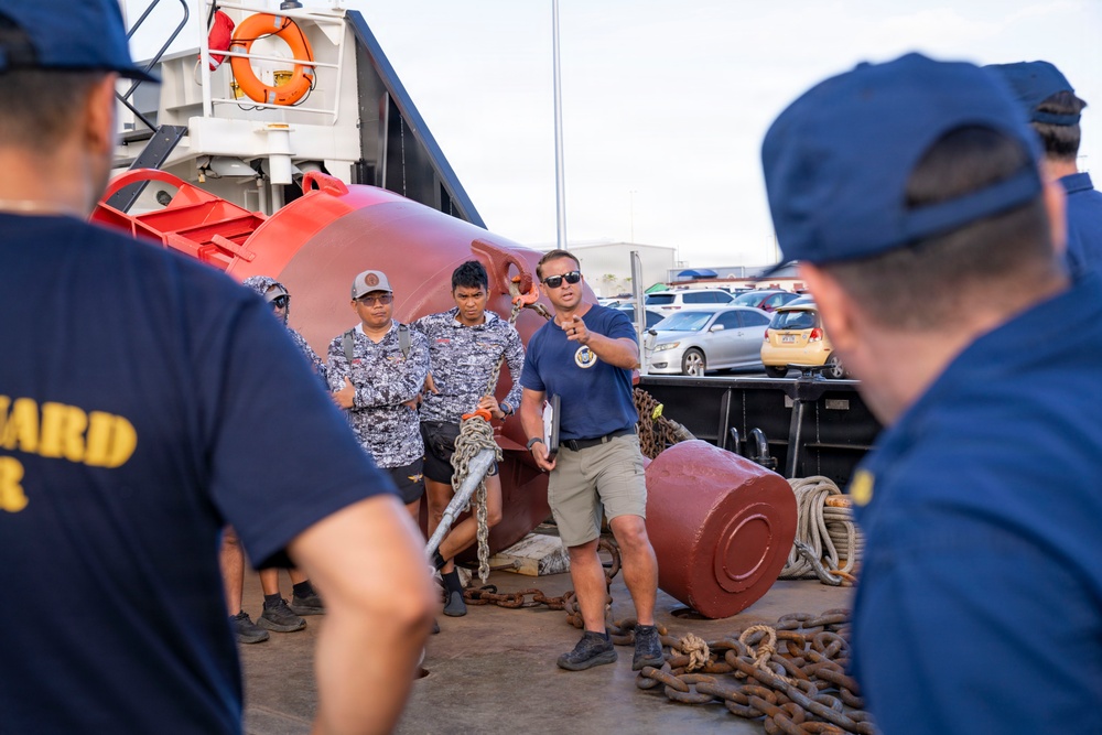 Partner nations participate in a buoy restoration project during RIMPAC 26