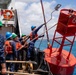 Partner nations participate in a buoy restoration project during RIMPAC 26