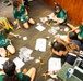94th Army Air and Missile Defense Command Soldiers assist YIP student athletes with rocket building