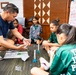 94th Army Air and Missile Defense Command Soldiers assist YIP student athletes with rocket building