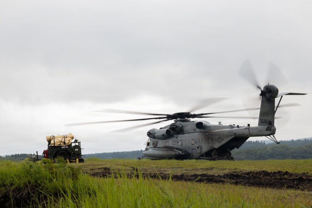 Helicopters land at a FARP site