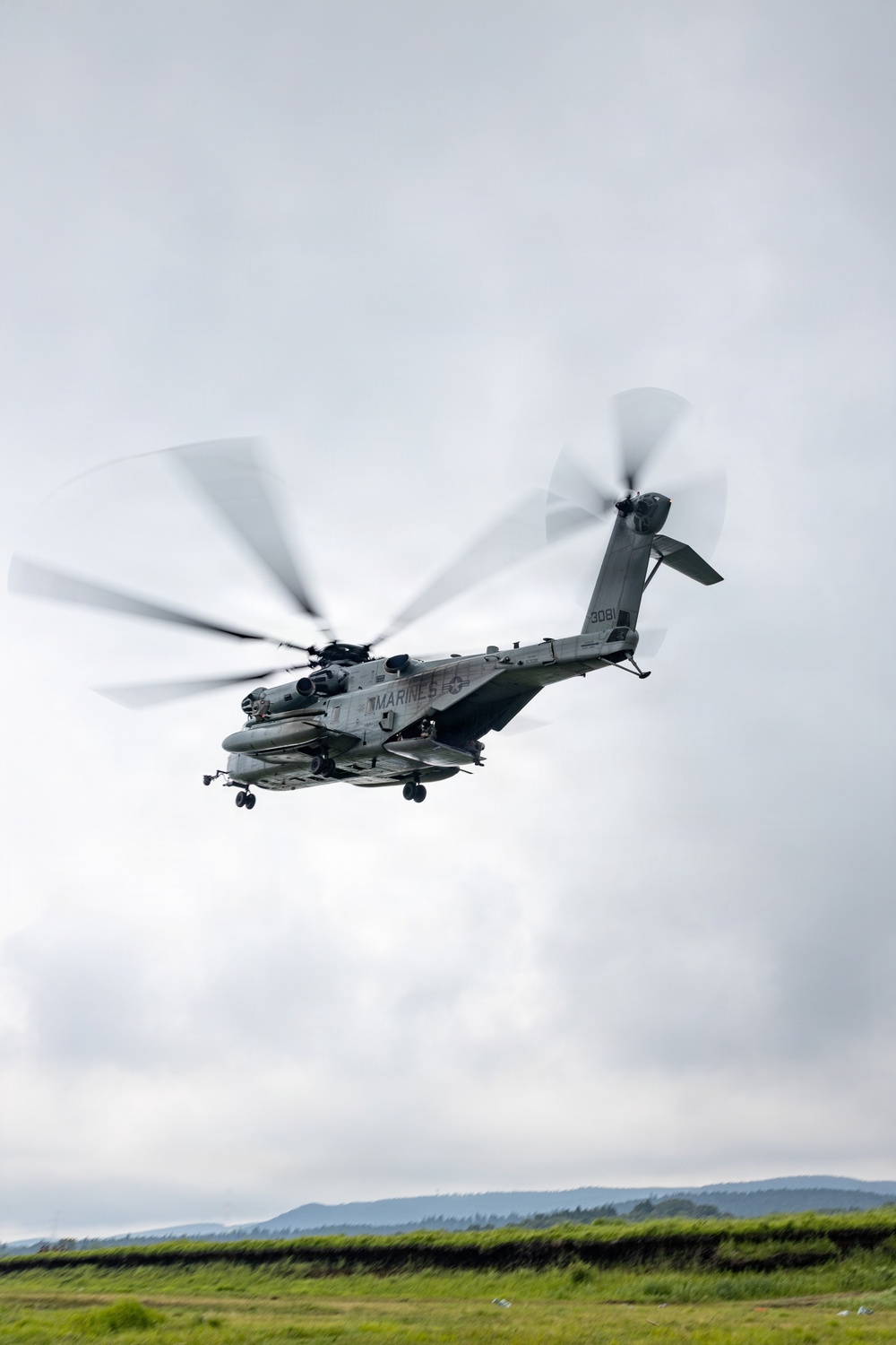 Helicopters land at a FARP site