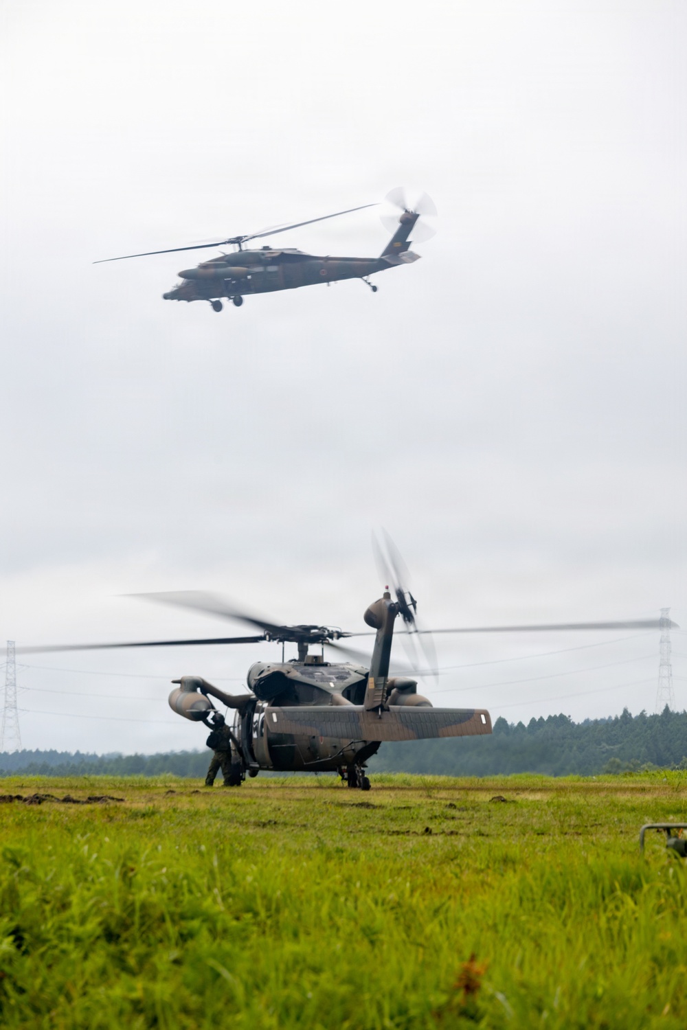 Helicopters land at a FARP site